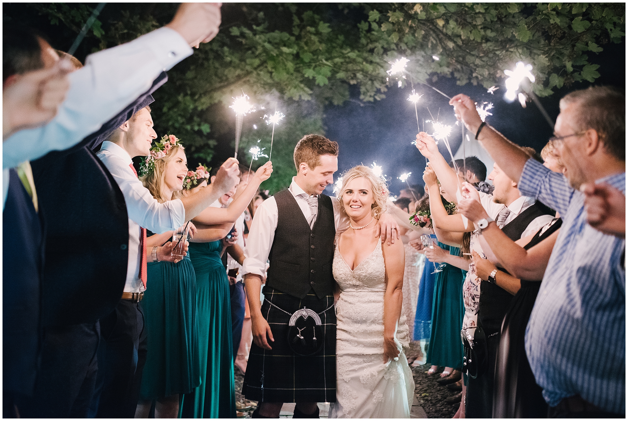 bride and groom with sparklers at oxwich bay hotel gower