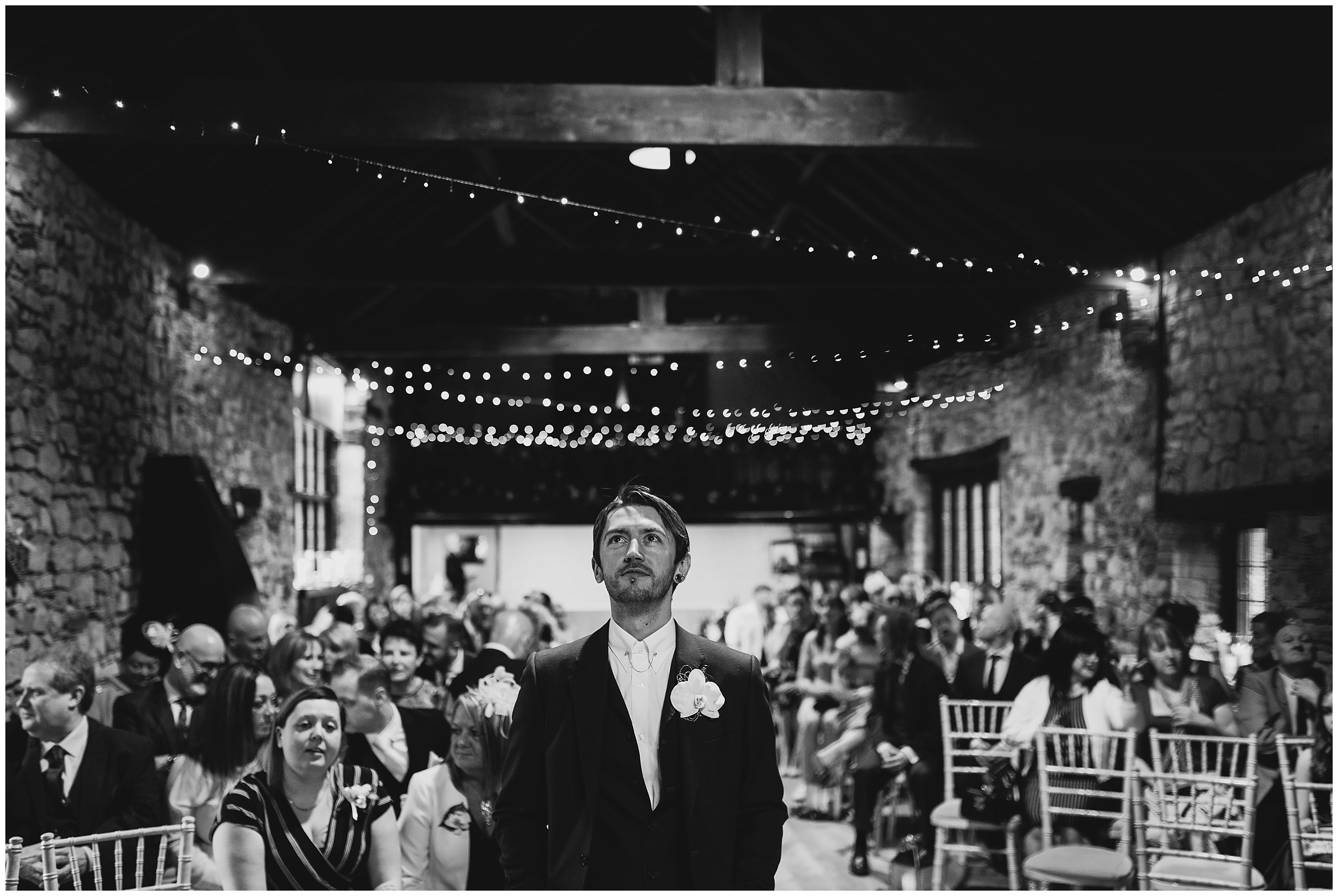 groom waiting at the end of the aisle